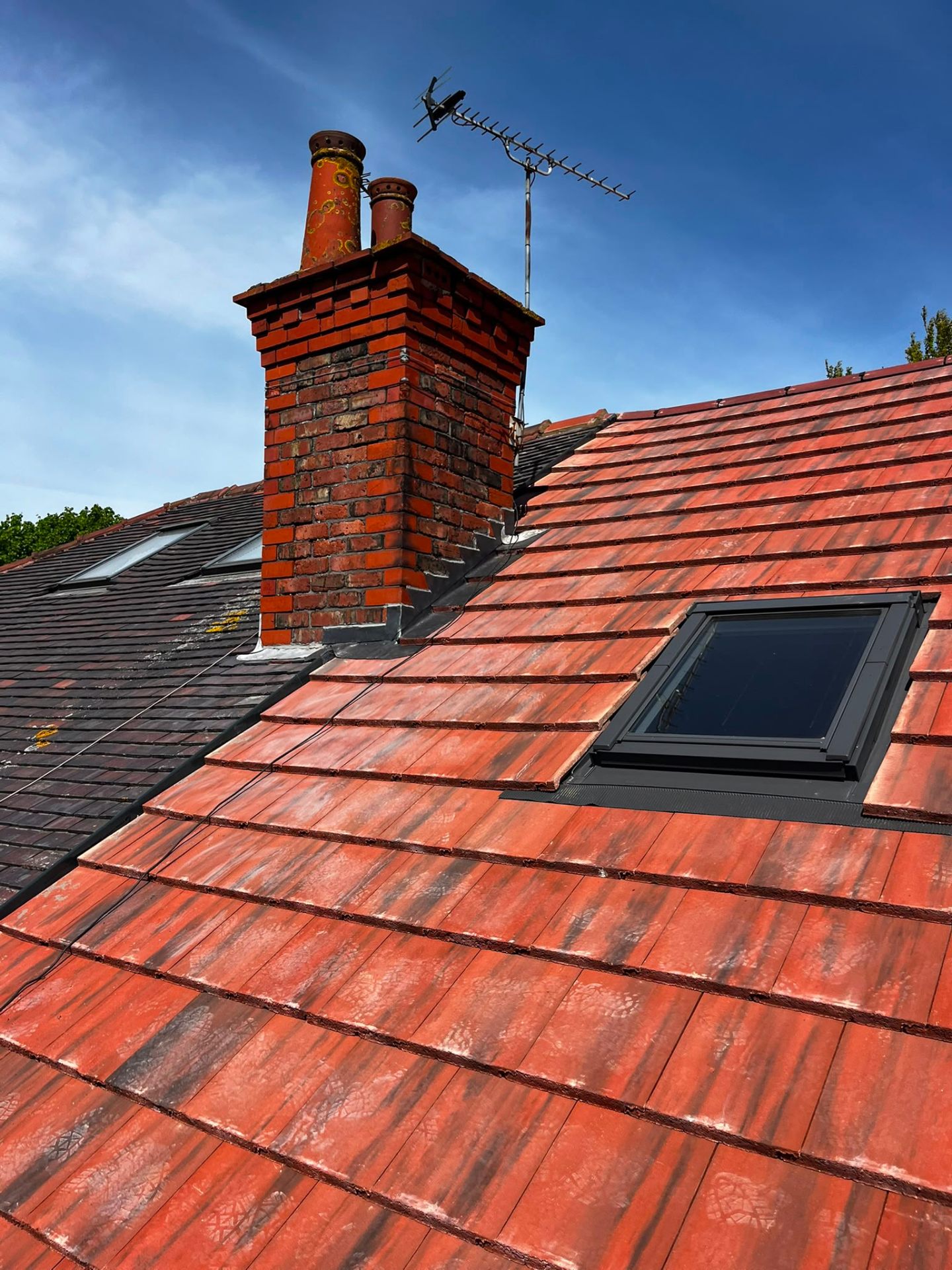 New red clay plain tile roof with tall Victorian chimney and Velux skylight, installed by RTC Roofing