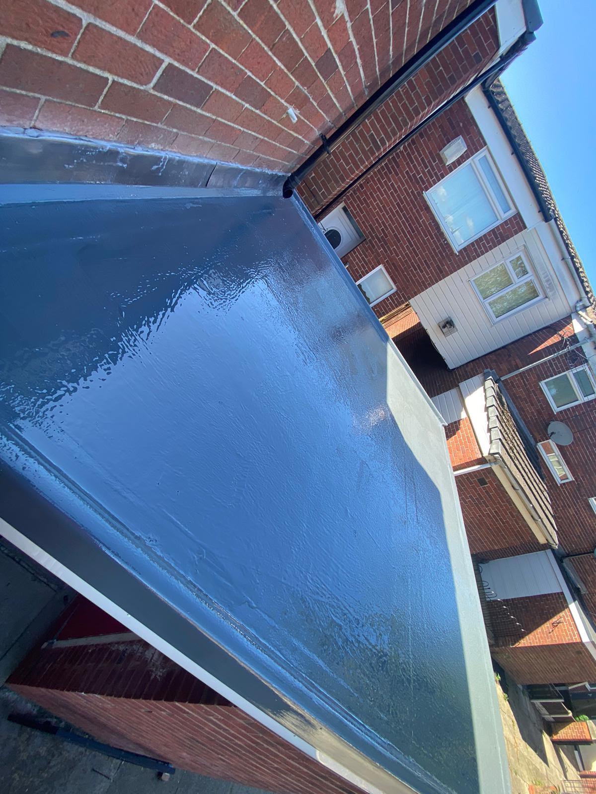 GRP fibreglass flat roof to a rear single-storey extension, freshly laid by RTC Roofing