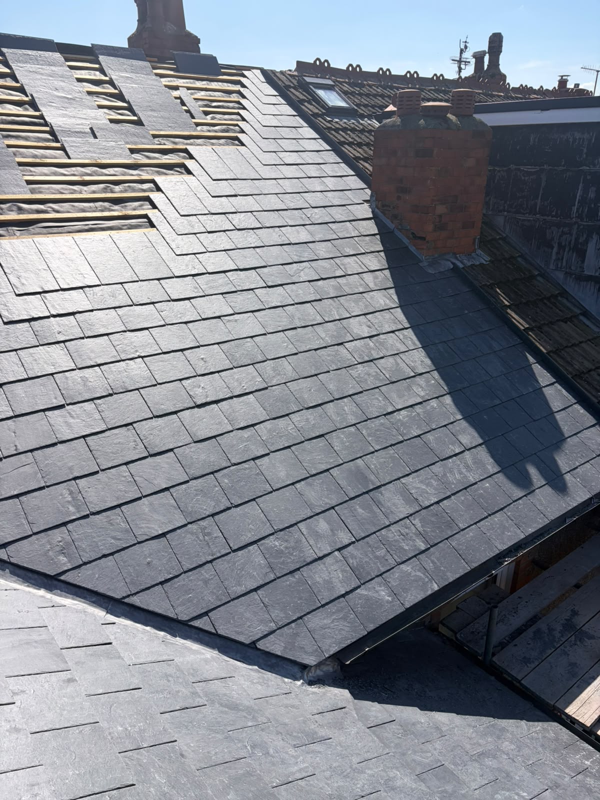 Natural slate re-roof in progress by RTC Roofing — new slates laid on treated battens over breathable membrane, Wirral