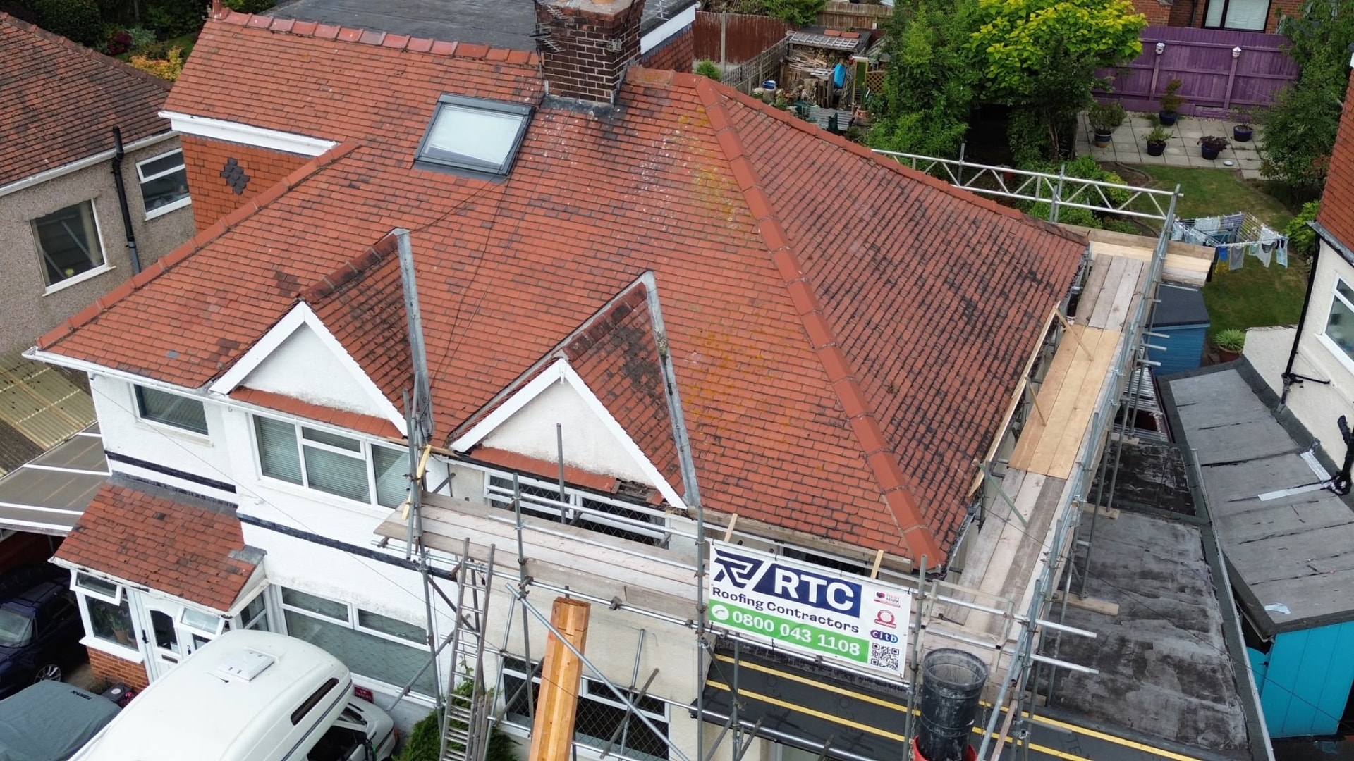 Before: tired, moss-stained red tile roof with worn ridge and failed pointing on a Wirral semi-detached home, photographed before RTC Roofing works